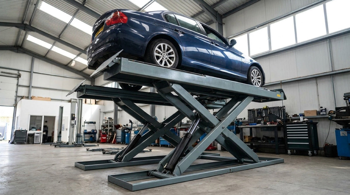 Full-rise scissor lift raising a car to working height in a workshop