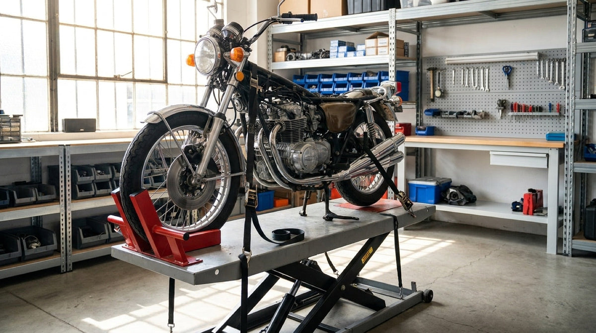 Motorcycle secured on a hydraulic lift table raised to working height in a workshop