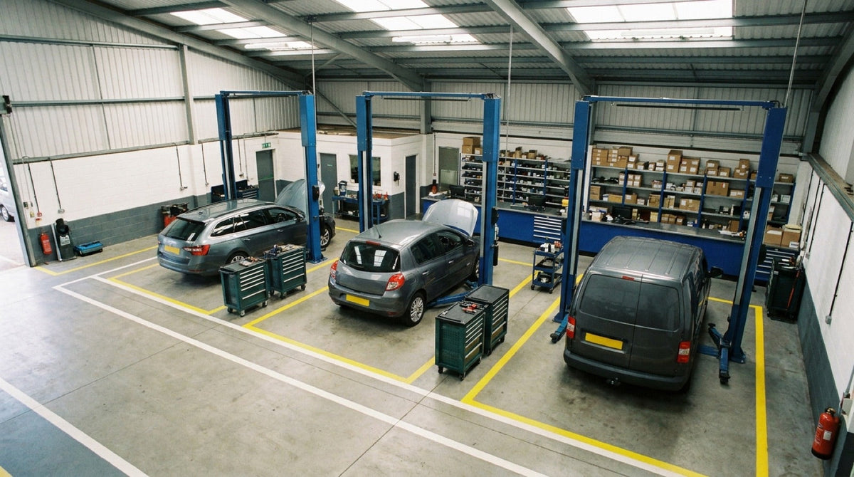 Well-organised multi-bay UK workshop with marked walkways and tidy tool trolleys